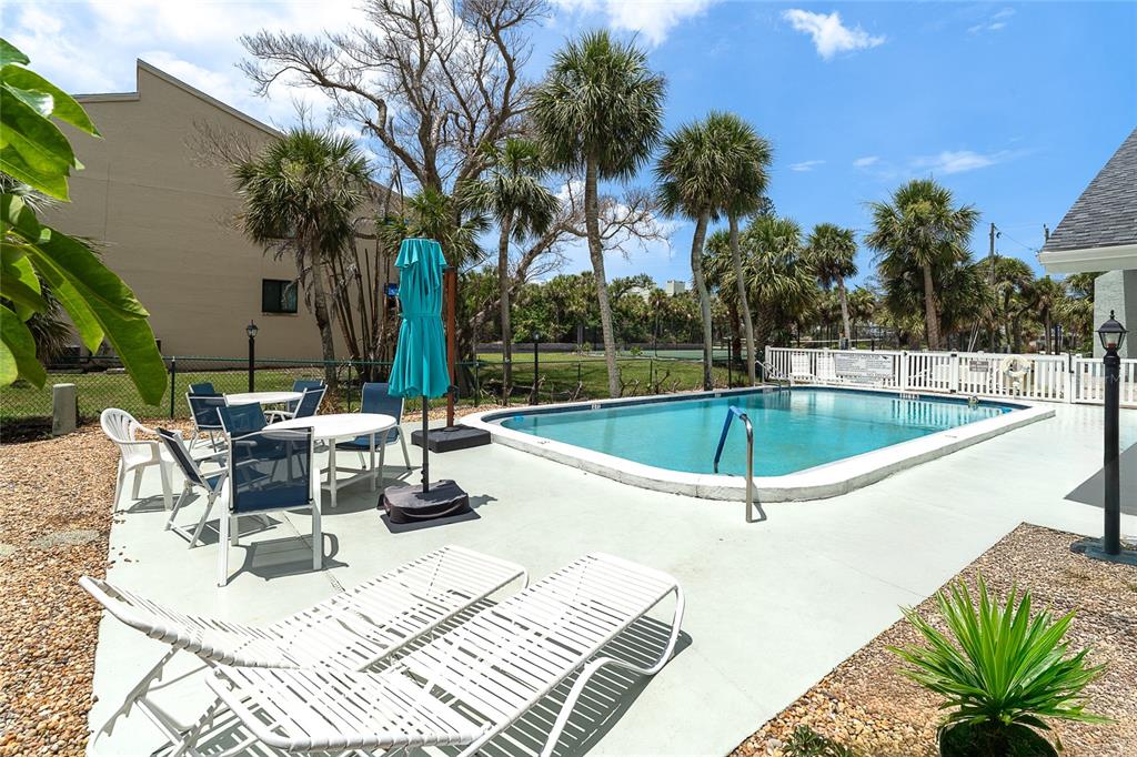 6005 North Beach Road, Unit 16 Englewood, FL 34223 - Photo 39 of 57 a view of a swimming pool with chairs