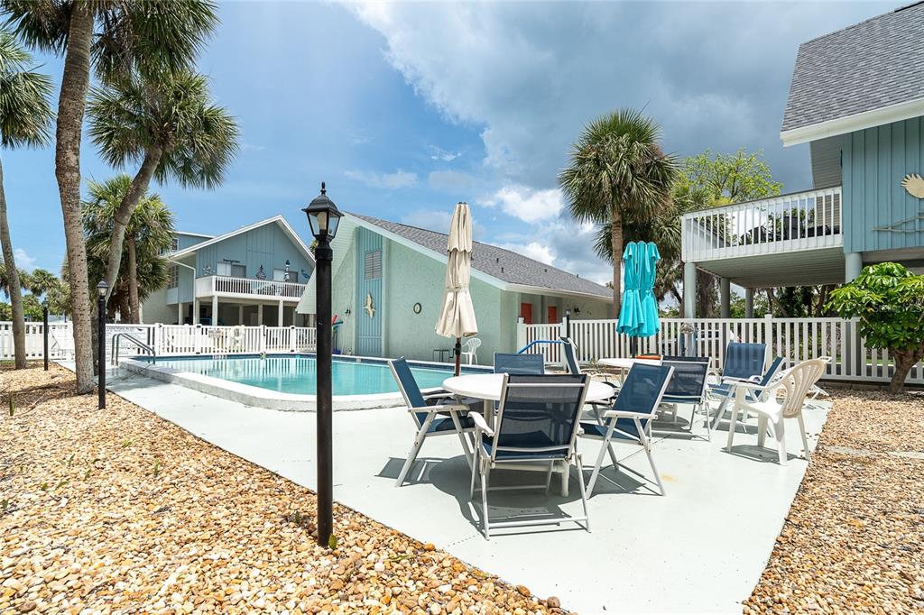 6005 North Beach Road, Unit 16 Englewood, FL 34223 - Photo 42 of 57 a view of a patio with a table and chairs
