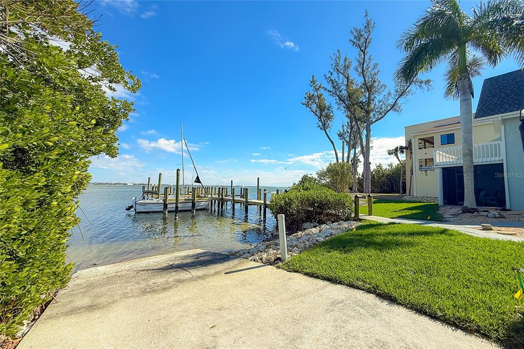 6005 North Beach Road, Unit 16 Englewood, FL 34223 - Photo 51 of 57 a view of a swimming pool with a yard and palm trees