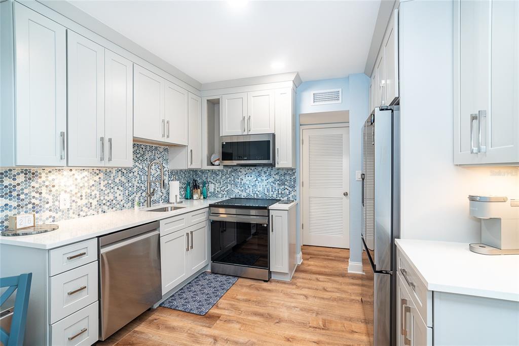 6005 North Beach Road, Unit 16 Englewood, FL 34223 - Photo 10 of 57 a kitchen with a sink stove and refrigerator