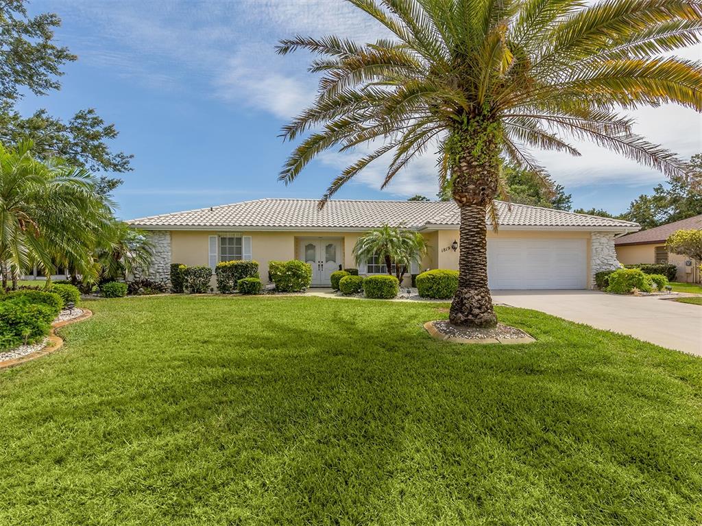 1819 Raintree Lane Venice, FL 34293 - Photo 1 of 1 a front view of a house with yard and green space