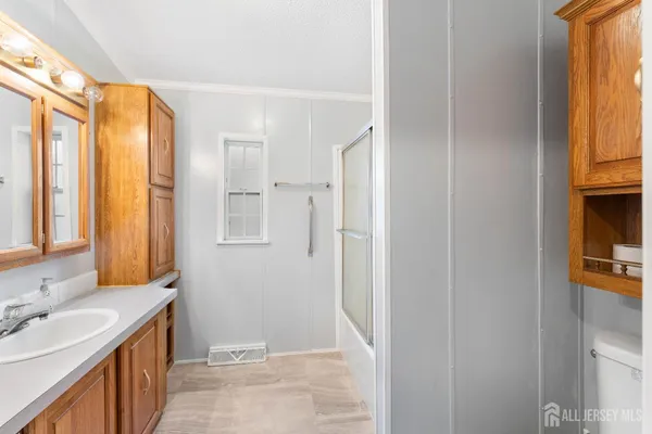 a bathroom with a sink a mirror and a shower
