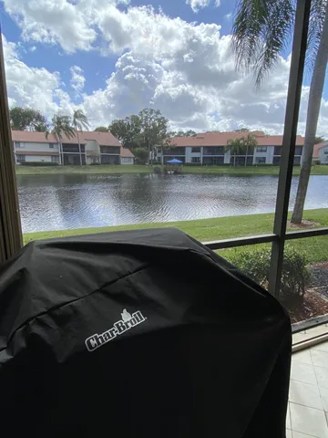 a bed sitting in a spacious bedroom next to a chandelier