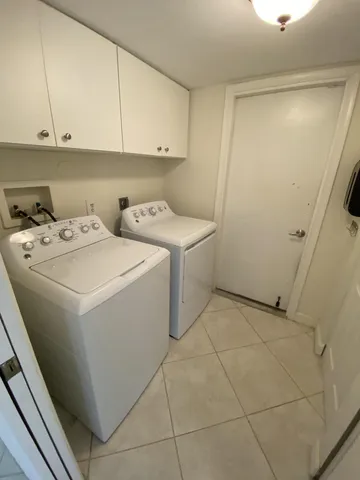 a view of a living room washer and dryer with kitchen view