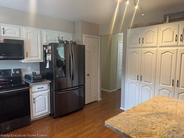 1467 Krafft Road, Unit 8 Port Huron, MI 48060 - Photo 9 of 28 Kitchen featuring wood-finish flooring and white cabinetry