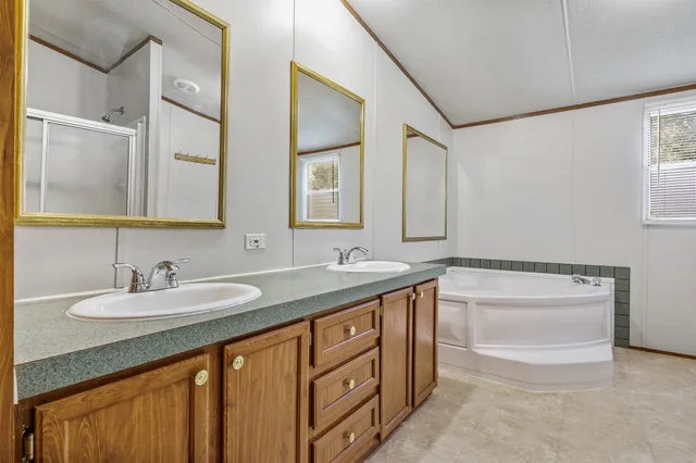 a spacious bathroom with a granite countertop sink a mirror and a