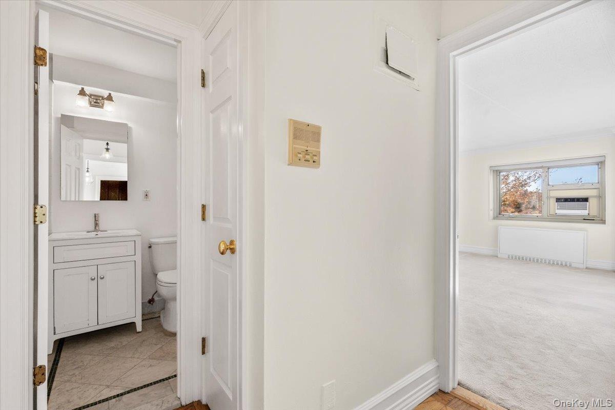 470 Halstead Avenue, Unit 5E Harrison, NY 10528 - Photo 12 of 22 a en suite bathroom with a shower sink and a mirror