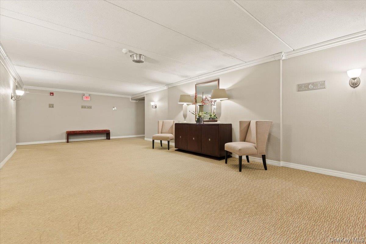 470 Halstead Avenue, Unit 5E Harrison, NY 10528 - Photo 20 of 22 a bed room with furniture and a chandelier