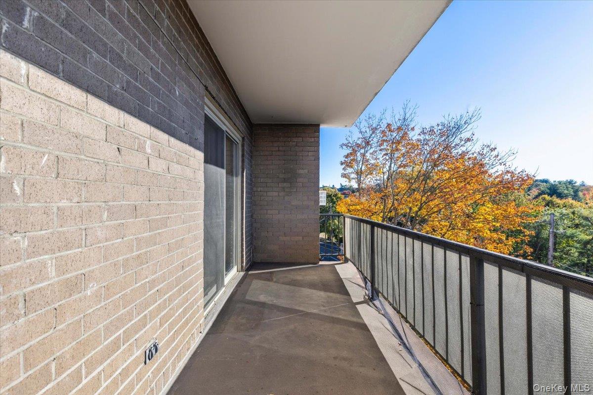 470 Halstead Avenue, Unit 5E Harrison, NY 10528 - Photo 21 of 22 a view of a balcony with wooden floor and fence