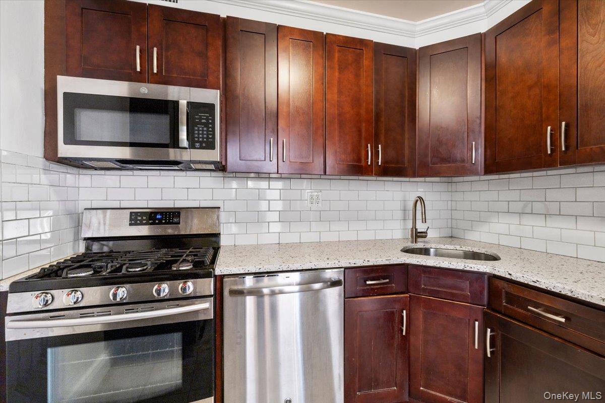 470 Halstead Avenue, Unit 5E Harrison, NY 10528 - Photo 7 of 22 a kitchen with granite countertop stainless steel appliances and cabinets
