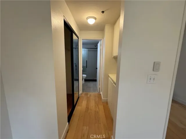 a view of a hallway with wooden floor and staircase
