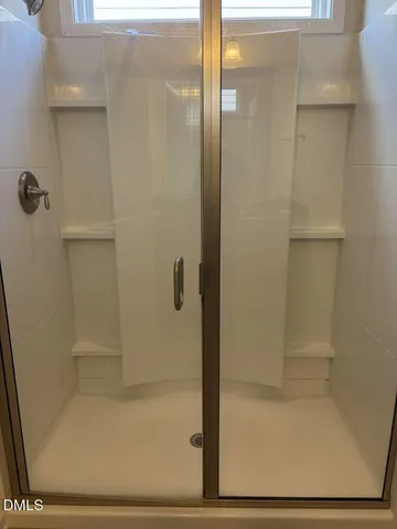 a bathroom with a glass shower door