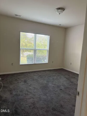 an empty room with a empty space and windows