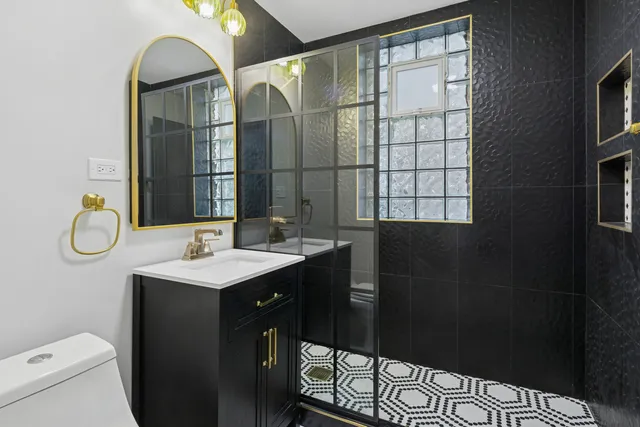 a bathroom with a double vanity sink toilet and a mirror