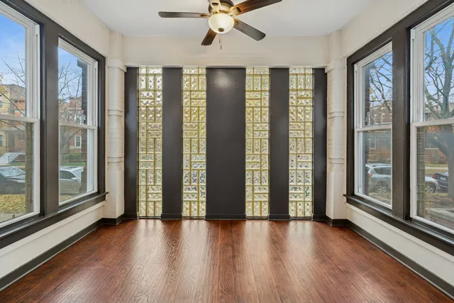 a view of an entryway with wooden floor and door