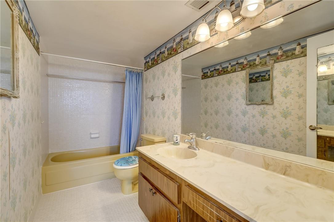1505 North Riverside Drive, Unit 1208 Pompano Beach, FL 33062 - Photo 27 of 62 a bathroom with a granite countertop sink a toilet a mirror and shower