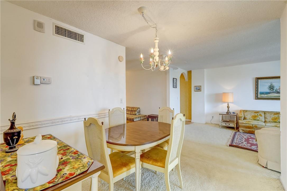 1505 North Riverside Drive, Unit 1208 Pompano Beach, FL 33062 - Photo 44 of 62 a dining room with furniture and a chandelier