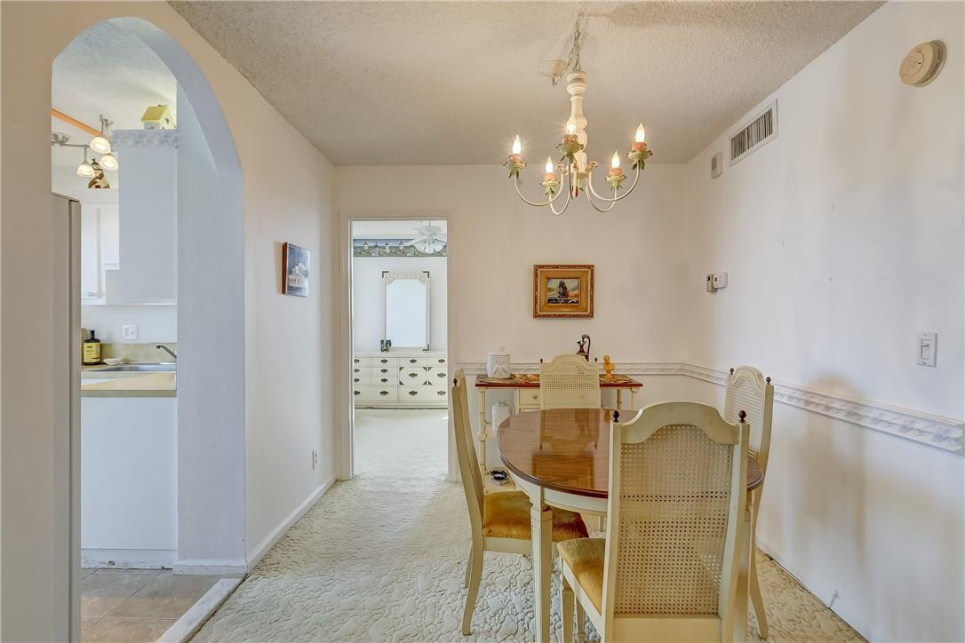 1505 North Riverside Drive, Unit 1208 Pompano Beach, FL 33062 - Photo 46 of 62 a dining room with furniture and chandelier
