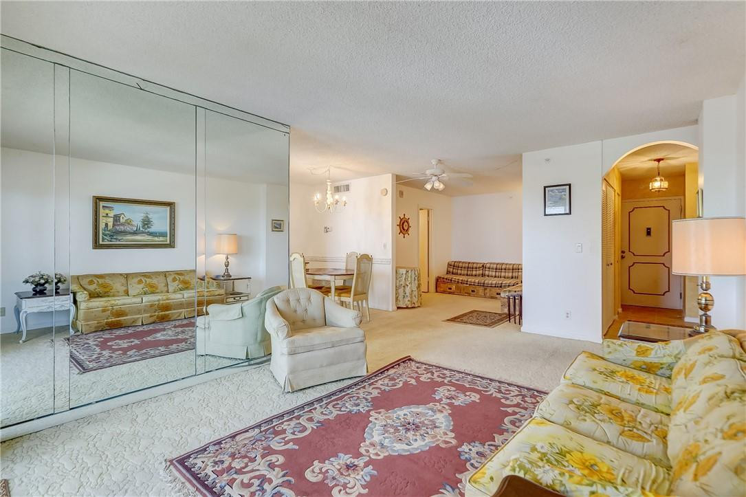 1505 North Riverside Drive, Unit 1208 Pompano Beach, FL 33062 - Photo 54 of 62 a spacious bedroom with a bed a couch and dresser
