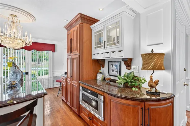 a kitchen with stainless steel appliances granite countertop a stove a sink and a dining table