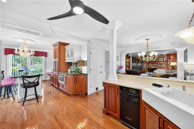 a kitchen with a sink cabinets and wooden floor