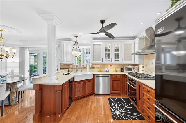 a large kitchen with stainless steel appliances granite countertop a sink and cabinets
