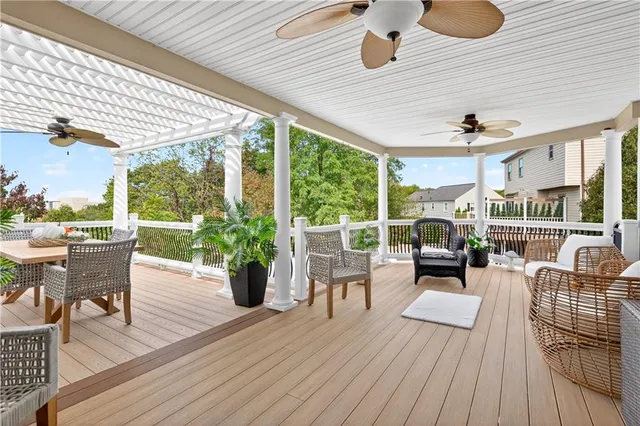 a living room with patio furniture and a floor to ceiling window