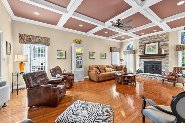 a living room with furniture fireplace and a large window