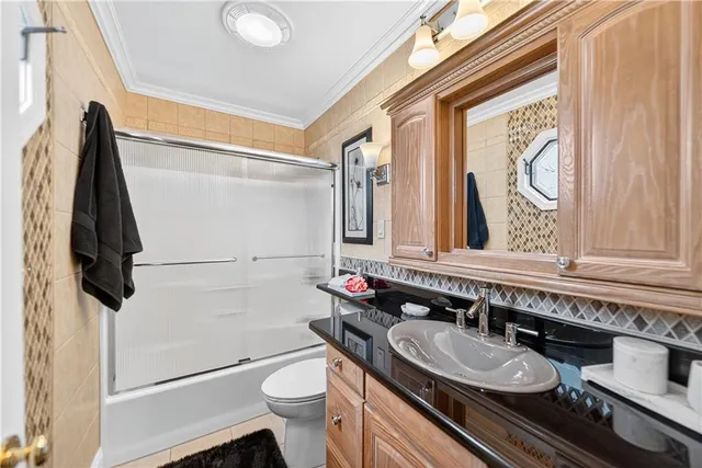 a bathroom with a granite countertop sink toilet and a mirror