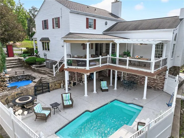 a view of a house with backyard porch and sitting area