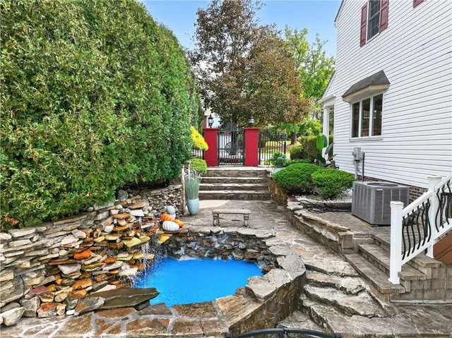 a front view of a house with a yard and a garden