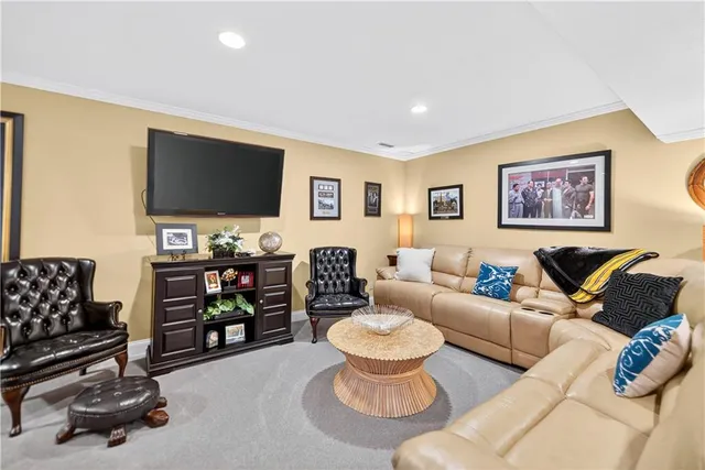 a living room with furniture a flat screen tv and a window