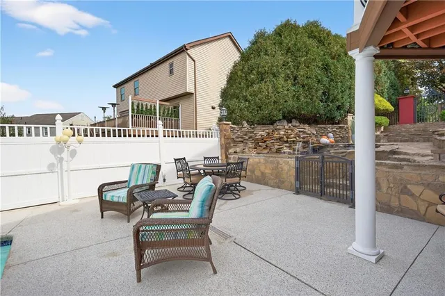 a view of a patio with a table and chairs