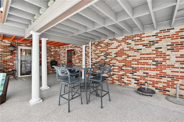 a view of a patio with table and chairs
