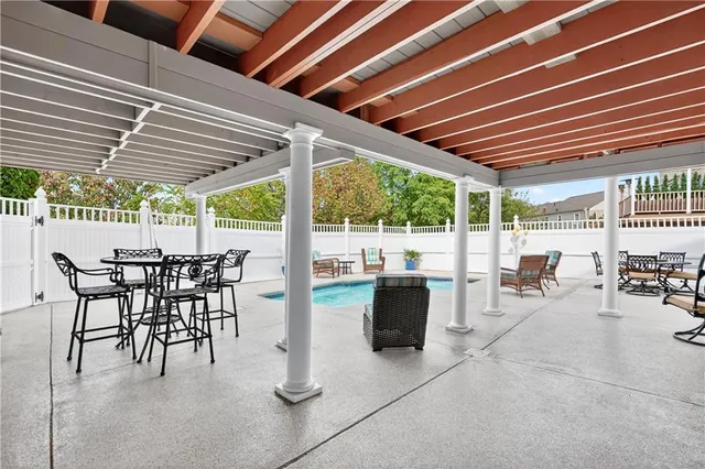 a view of a patio with table and chairs and potted plants