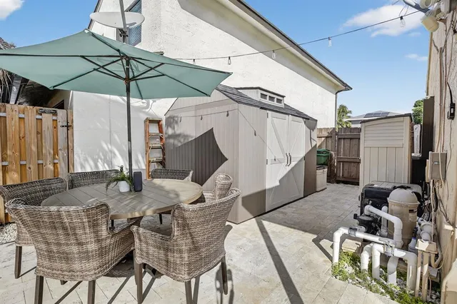 a view of a house with swimming pool and sitting area