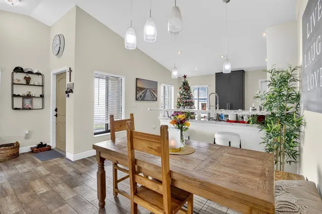 a kitchen with wooden floor and a refrigerator
