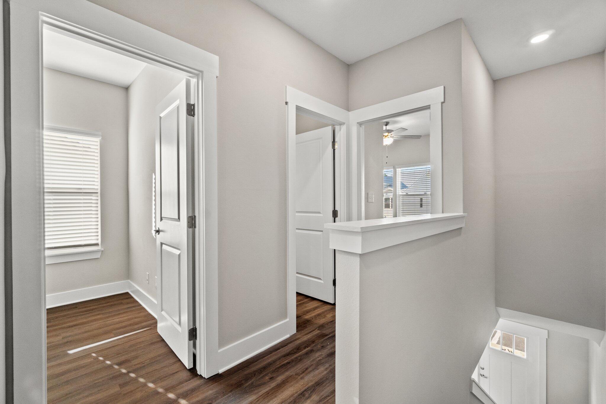 274 Date Palm Lane, Unit HORIZON Freeport, FL 32439 - Photo 13 of 28 a view of a hallway with wooden floor and cabinets