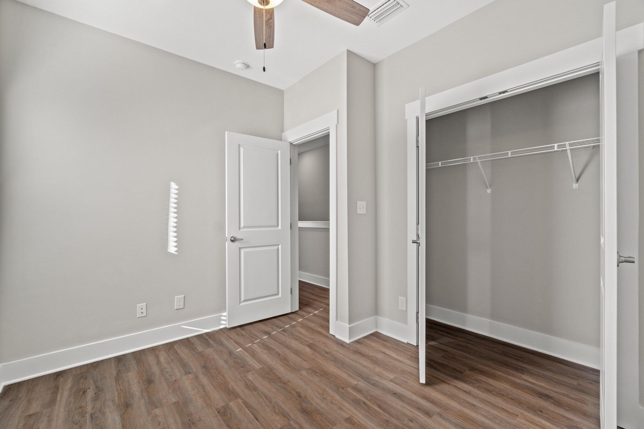 274 Date Palm Lane, Unit HORIZON Freeport, FL 32439 - Photo 15 of 28 an empty room with wooden floor and closet