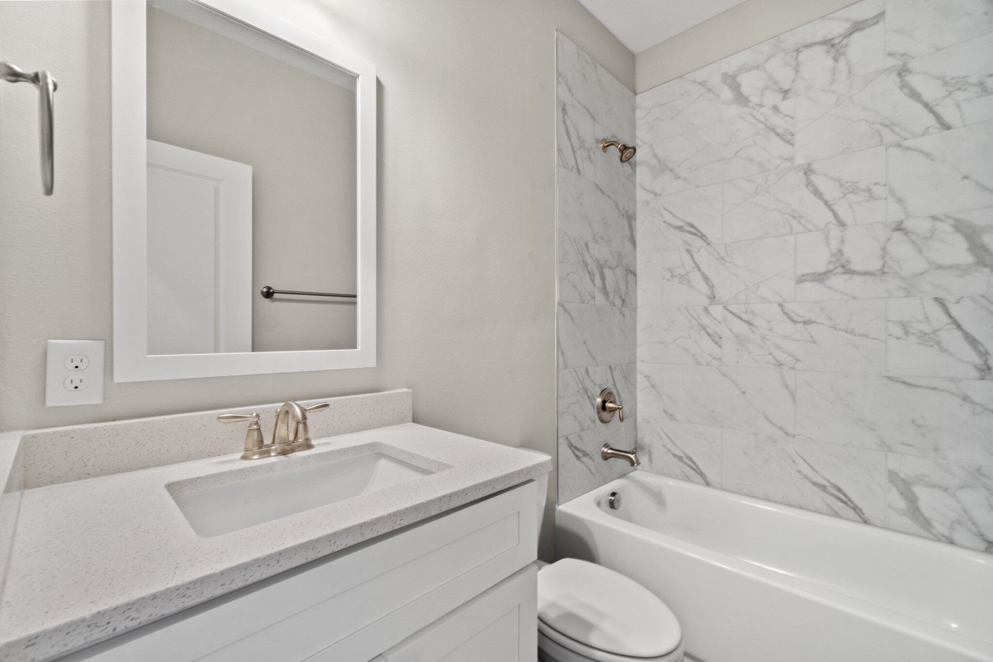 274 Date Palm Lane, Unit HORIZON Freeport, FL 32439 - Photo 16 of 28 a bathroom with a granite countertop sink toilet and shower