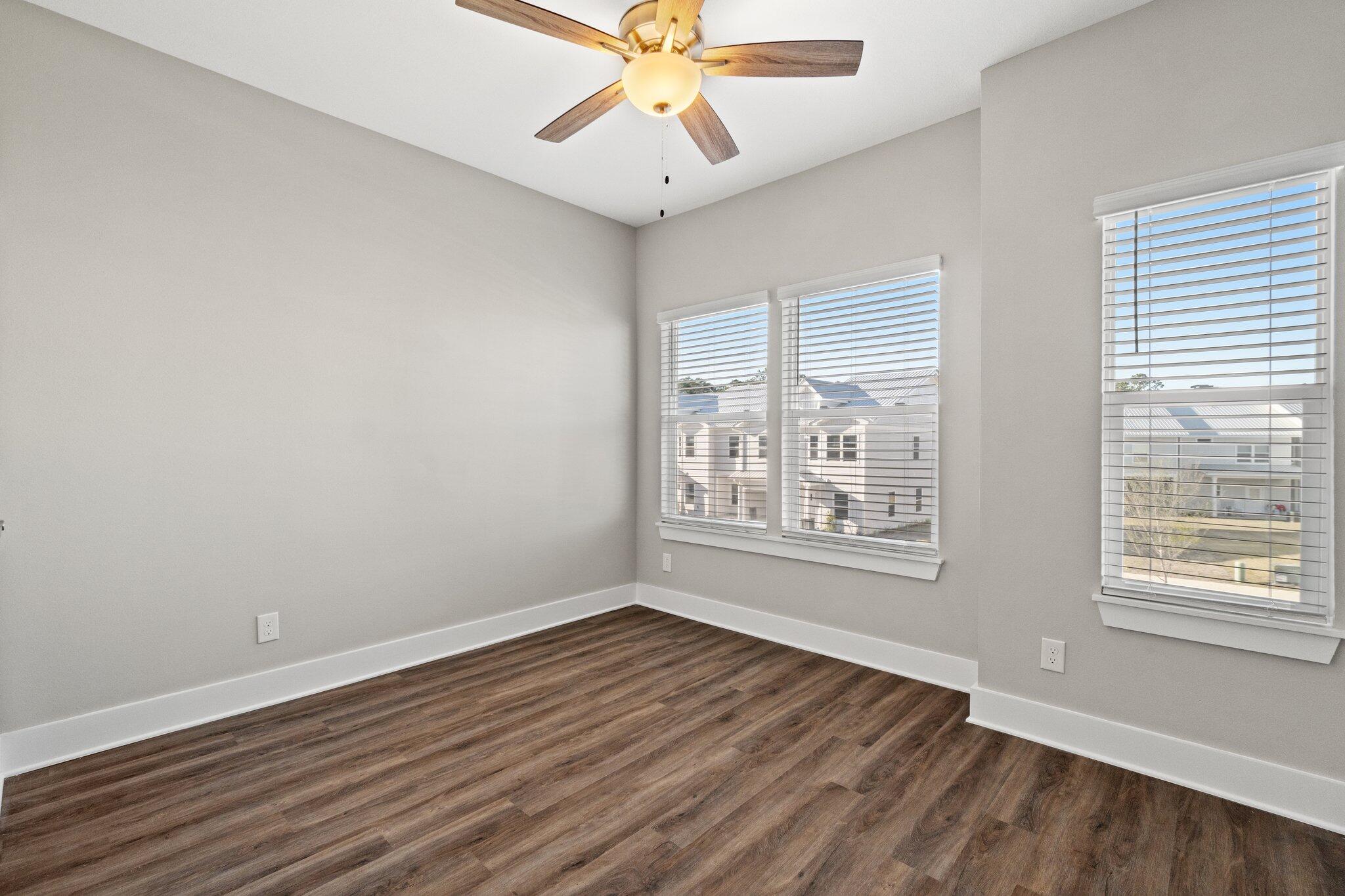 274 Date Palm Lane, Unit HORIZON Freeport, FL 32439 - Photo 17 of 28 a view of an empty room with wooden floor and a window