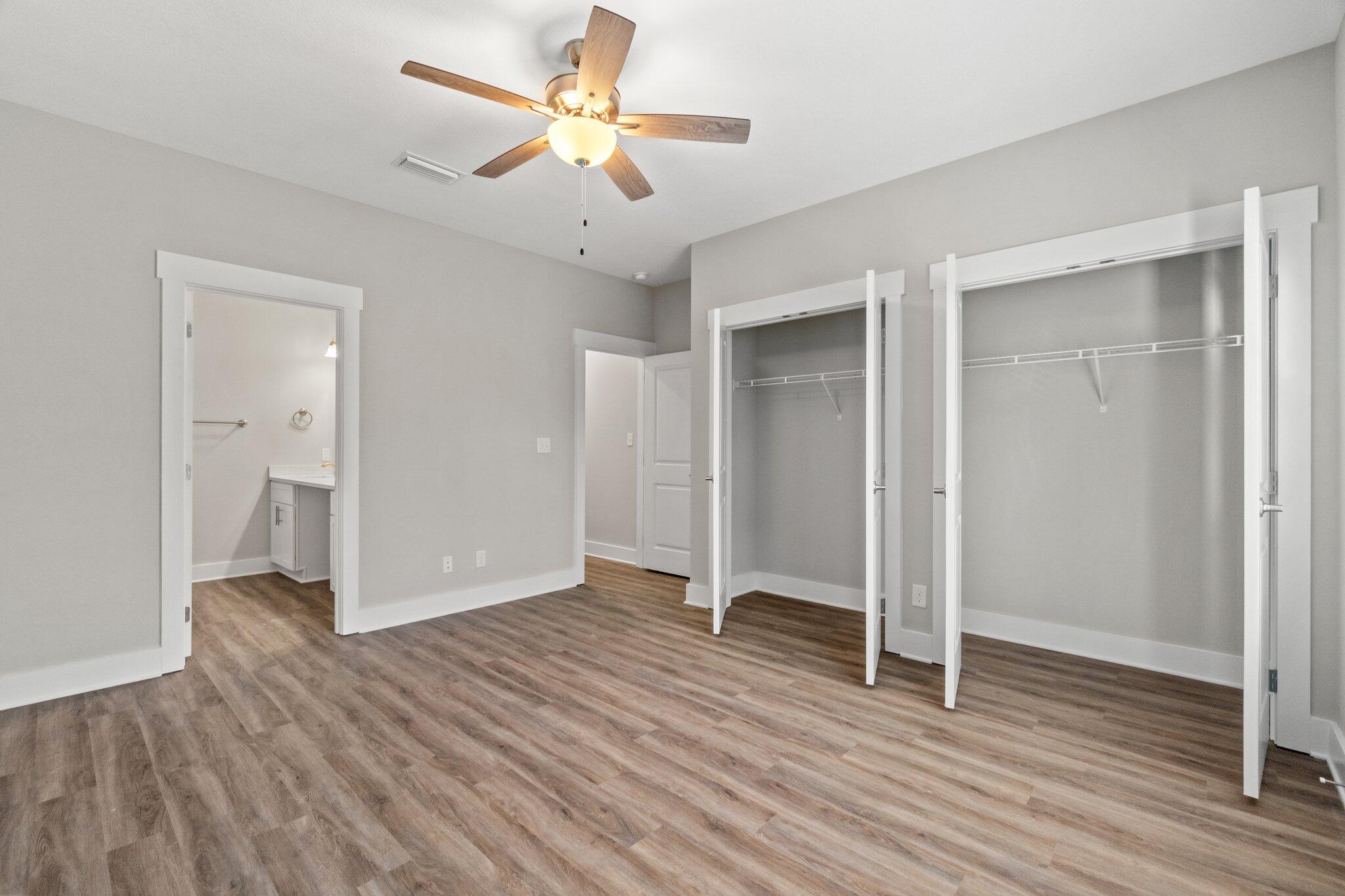 274 Date Palm Lane, Unit HORIZON Freeport, FL 32439 - Photo 20 of 28 an empty room with wooden floor and a ceiling fan
