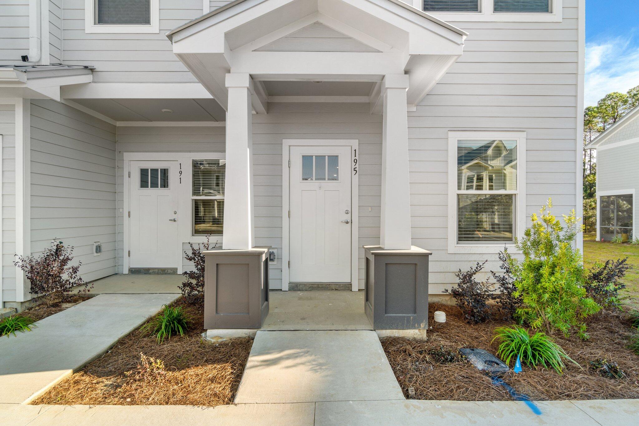 274 Date Palm Lane, Unit HORIZON Freeport, FL 32439 - Photo 2 of 28 a front view of a house with garden
