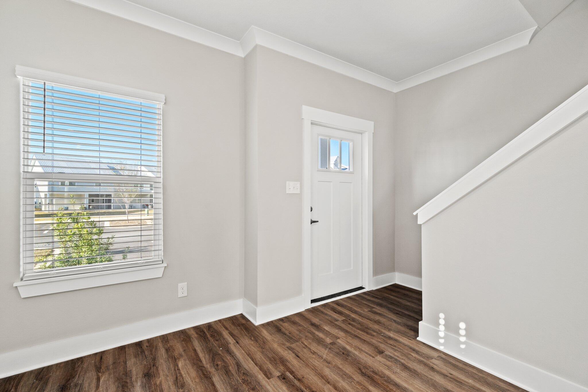 274 Date Palm Lane, Unit HORIZON Freeport, FL 32439 - Photo 3 of 28 a view of an empty room with wooden floor and a window