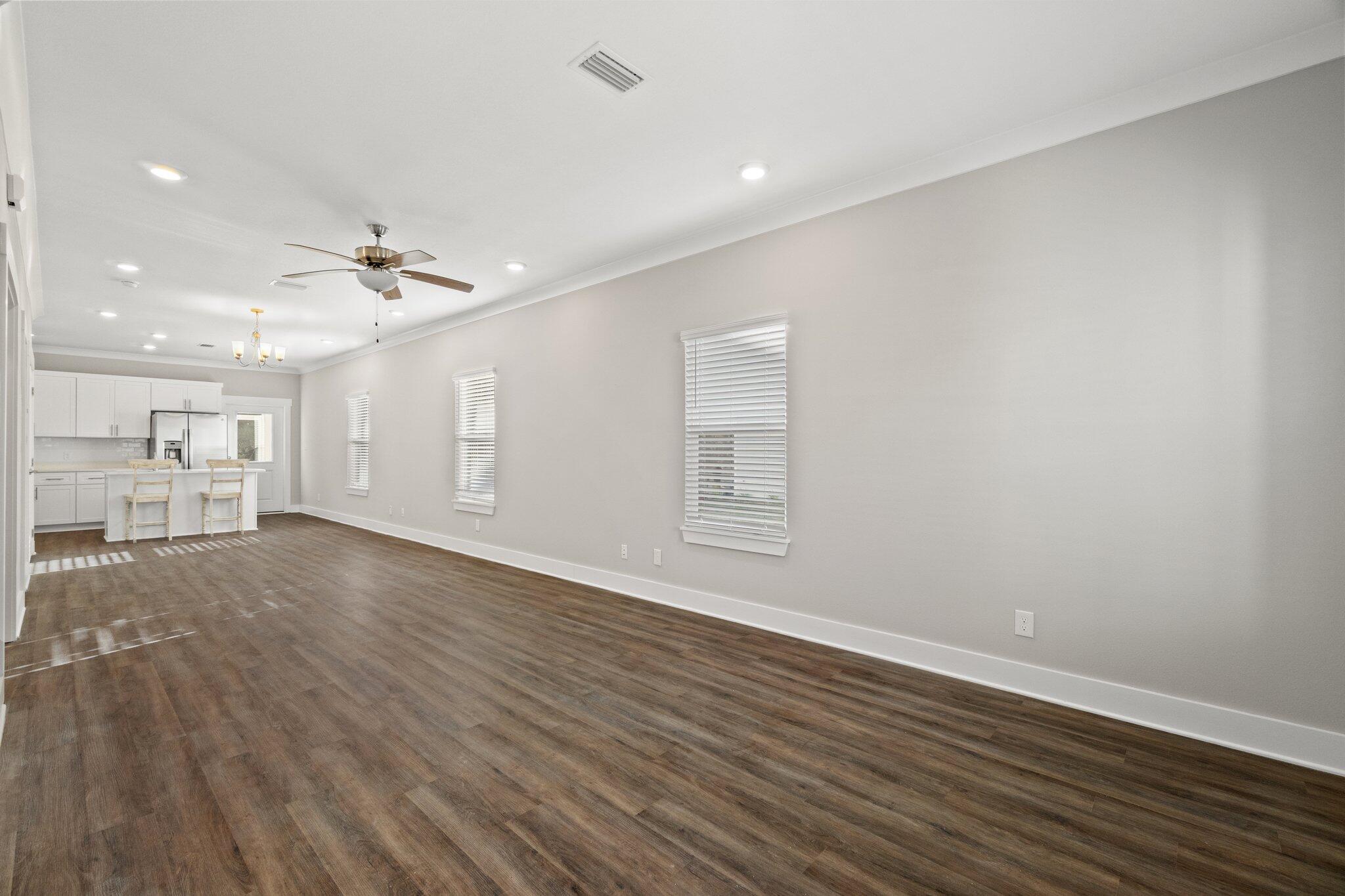 274 Date Palm Lane, Unit HORIZON Freeport, FL 32439 - Photo 4 of 28 a view of an empty room with wooden floor and a window