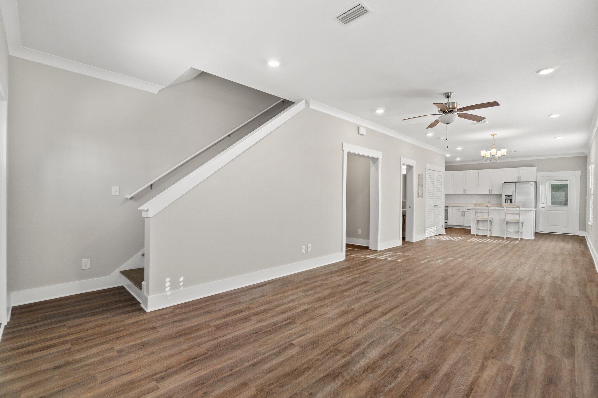 274 Date Palm Lane, Unit HORIZON Freeport, FL 32439 - Photo 5 of 28 a view of an empty room with wooden floor and a ceiling fan