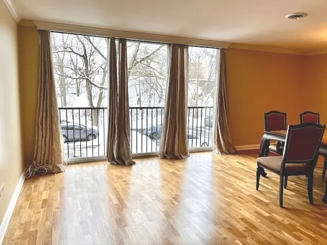 a view of a bedroom with furniture and wooden floor
