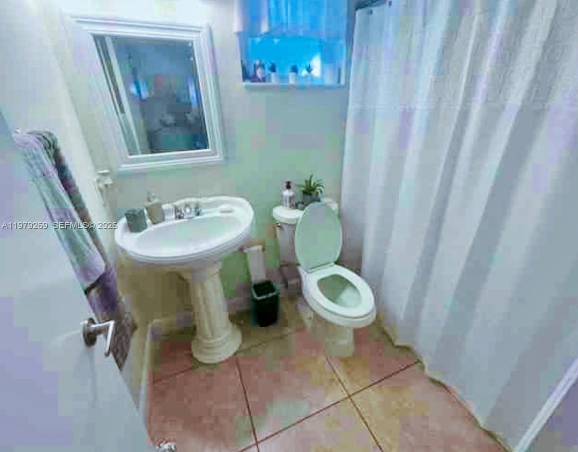 4734 Southwest 4th Street Miami, FL 33134 - Photo 21 of 23 a bathroom with a toilet and sink