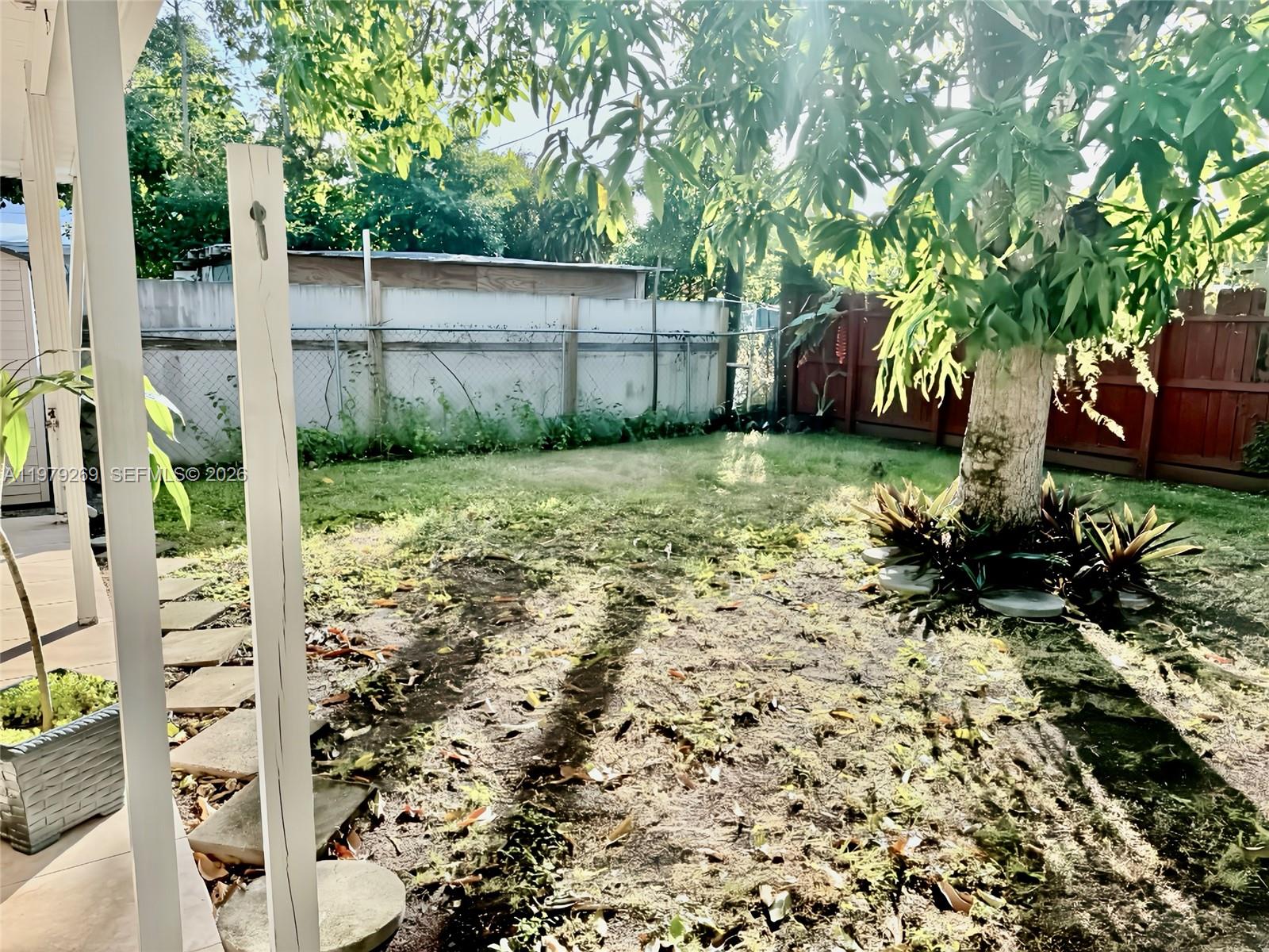4734 Southwest 4th Street Miami, FL 33134 - Photo 23 of 23 a backyard of a house with a large tree and plants