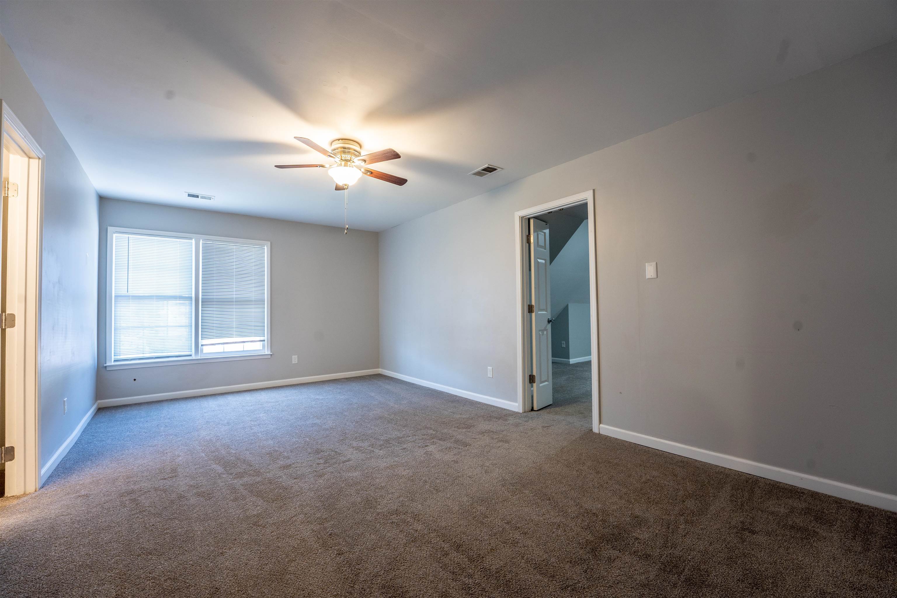 8747 Walnut Grove Road Memphis, TN 38018 - Photo 21 of 25 a view of empty room with windows